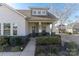 Charming exterior of a well-maintained home featuring a cozy front porch and landscaped yard at 15035 Batteliere Dr, Charlotte, NC 28278