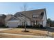 Beautiful single-Gathering home with attached garage, manicured lawn, and charming architectural details at 15035 Batteliere Dr, Charlotte, NC 28278