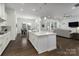 Open-concept kitchen with island that connects to the dining and living areas at 15035 Batteliere Dr, Charlotte, NC 28278