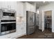 Kitchen with built in microwave, oven, and stainless steel refrigerator at 15035 Batteliere Dr, Charlotte, NC 28278
