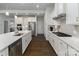 Stylish white kitchen with stainless steel appliances and ample counter space at 15035 Batteliere Dr, Charlotte, NC 28278