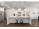 Well-lit kitchen with a center island and pendant lighting above the stools at 15035 Batteliere Dr, Charlotte, NC 28278