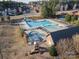 Aerial shot of community pool with slide, adjacent tennis courts, and surrounding residential neighborhood at 15035 Batteliere Dr, Charlotte, NC 28278