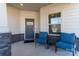 Inviting front porch with blue chairs, stone accents, and a 