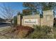 Community sign for The Meridians is set amidst landscaping and a brick entryway at 15035 Batteliere Dr, Charlotte, NC 28278