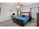 Spacious bedroom with a king bed, ceiling fan, and a dedicated workspace at 16504 Knox Run Rd, Huntersville, NC 28078
