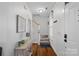 Inviting foyer with hardwood floors, stairs, and a decorative table with greenery at 16504 Knox Run Rd, Huntersville, NC 28078