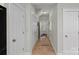 Hallway with tiled flooring and white doors, leading to various rooms in the home at 16504 Knox Run Rd, Huntersville, NC 28078