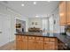 Bright kitchen with granite countertops, wooden cabinets, and an adjacent dining area at 16504 Knox Run Rd, Huntersville, NC 28078