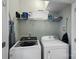 Well-equipped laundry room with a washer, dryer, and storage shelves for supplies at 16504 Knox Run Rd, Huntersville, NC 28078
