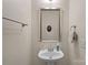 Cozy powder room features a pedestal sink, decorative mirror, and neutral wall color at 16504 Knox Run Rd, Huntersville, NC 28078
