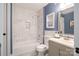 Bathroom featuring a bathtub with marble tiled backsplash, toilet and vanity at 1703 Luther St, Charlotte, NC 28204