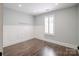 Bedroom with hardwood floors, wainscoting and a window with plantation shutters at 1703 Luther St, Charlotte, NC 28204