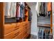 Walk-in closet with wood shelving, drawers and hanging rods for ample storage at 1703 Luther St, Charlotte, NC 28204