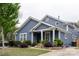 Stylish blue two-story home with white trim, a well-kept lawn, and an inviting entrance at 1703 Luther St, Charlotte, NC 28204