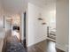 View of a well-lit hallway featuring hardwood floors and access to living spaces and stairs at 1703 Luther St, Charlotte, NC 28204