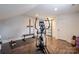 Bright home gym featuring an elliptical machine, free weights, and sliding barn door at 1703 Luther St, Charlotte, NC 28204