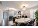 Bright and airy living and dining area featuring hardwood floors, modern lighting, and stylish decor at 1703 Luther St, Charlotte, NC 28204