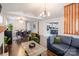 Open-concept living area with hardwood floors, modern furnishings, and a seamless flow to the kitchen at 1703 Luther St, Charlotte, NC 28204