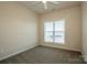 Bedroom with neutral carpet, blinds on the window, and a ceiling fan at 19915 Lamp Lighters Way, Cornelius, NC 28031