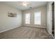 Neutral bedroom offers large windows for natural light, neutral paint and carpet at 19915 Lamp Lighters Way, Cornelius, NC 28031