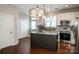 Bright kitchen features an island, stainless appliances, and a modern, decorative light fixture at 19915 Lamp Lighters Way, Cornelius, NC 28031