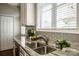 Kitchen sink with granite countertops and stainless steel faucet at 19915 Lamp Lighters Way, Cornelius, NC 28031