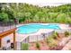 Community pool surrounded by lush landscaping, with a pergola, various tables and lounge chairs at 19915 Lamp Lighters Way, Cornelius, NC 28031