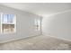 The bedroom features carpeted floors, neutral paint colors, and bright light from two windows at 2131 Belterra Dr, Charlotte, NC 28216