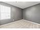 Cozy bedroom with neutral carpet, large window, and painted grey walls at 2131 Belterra Dr, Charlotte, NC 28216