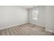 Bright bedroom with a view out of the window and neutral colored carpet at 2131 Belterra Dr, Charlotte, NC 28216