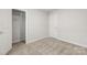 Clean bedroom with carpeted floor, white trim and interior doors, and an open closet with wire shelving at 2131 Belterra Dr, Charlotte, NC 28216