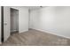 Bright bedroom with neutral carpet and white walls, featuring a closet with wire shelving at 2131 Belterra Dr, Charlotte, NC 28216