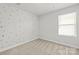 Bright, empty bedroom with a large window and a polka dot accent wall at 2131 Belterra Dr, Charlotte, NC 28216