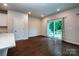 Open concept dining space with hardwood flooring, access to a patio, and right next to the kitchen at 2131 Belterra Dr, Charlotte, NC 28216