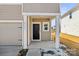 View of a covered front porch with white columns and a black front door at 2131 Belterra Dr, Charlotte, NC 28216
