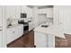 Bright kitchen features white cabinets, stainless steel appliances, white countertops and an island at 2131 Belterra Dr, Charlotte, NC 28216