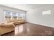 Spacious living room featuring hardwood floors and multiple windows at 2131 Belterra Dr, Charlotte, NC 28216