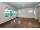 Bright living room with a large window, hardwood flooring, neutral paint, and lots of square footage at 2131 Belterra Dr, Charlotte, NC 28216