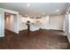 Spacious living space with hardwood flooring, neutral paint color, lots of natural light, and easy kitchen access at 2131 Belterra Dr, Charlotte, NC 28216