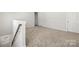 The loft features carpeted floors, neutral paint colors, and bright light at 2131 Belterra Dr, Charlotte, NC 28216