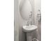 The powder room features a pedestal sink, round mirror, chrome hardware, and a towel rack at 2131 Belterra Dr, Charlotte, NC 28216