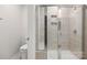 Bright shower with chrome shower head, seating and tiled walls and clear glass door at 2131 Belterra Dr, Charlotte, NC 28216