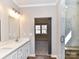 Bathroom with double vanity, marble countertop, open doorway to carpeted bedroom, and a glass door shower at 2328 Kingsburry Rd, York, SC 29745