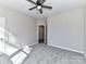 Bedroom featuring carpet, a ceiling fan, and a door leading to the en-suite bathroom at 2328 Kingsburry Rd, York, SC 29745