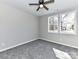 Bedroom with carpet, ceiling fan, and two windows offering natural light and views of the outdoors at 2328 Kingsburry Rd, York, SC 29745