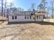 View of the home's rear exterior showcasing modern construction, covered porch, and fenced backyard at 2328 Kingsburry Rd, York, SC 29745