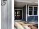 View of the front door featuring a glass paneled wooden door with side panel windows and gray siding at 2328 Kingsburry Rd, York, SC 29745