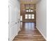 Inviting hallway with wood-look floors leading to a bright living space featuring a vaulted ceiling at 2328 Kingsburry Rd, York, SC 29745