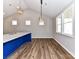 Bright kitchen features modern lighting, luxury vinyl flooring, and a blue kitchen island at 2328 Kingsburry Rd, York, SC 29745